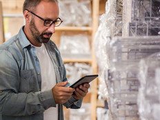 Man using tablet to check retail inventory 
