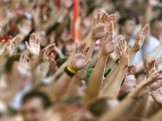 Football fans clapping on the podium of the stadium