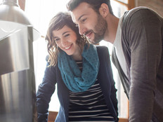 Two young people, a woman and man, working in an office and looking at a computer monitor