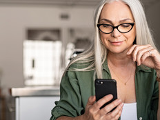 woman with iphone and mac thinking about user experience