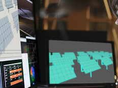 Man with multiple monitors charts