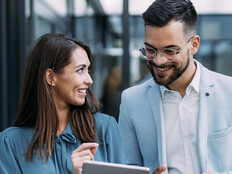 Business people using digital tablet outdoors