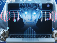 Hacker holding computer with floating face representing AI cyberattacks