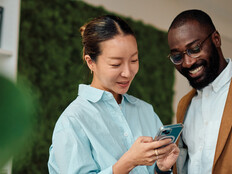 IT leaders holding an android phone in workspace