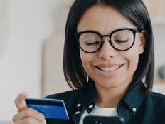 Person paying with card and a phone