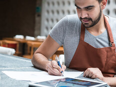 Business man reviewing data at a restaurant