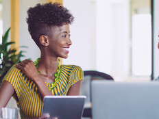 small business owners smile around computer
