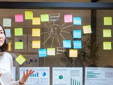 Biz Woman talking at a board with AI & charts