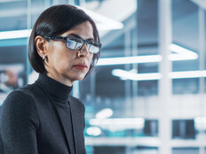 woman looks at computer monitor in office