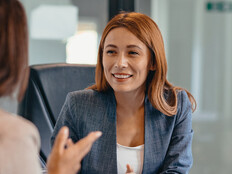 Three professionals in a discussion at an office meeting
