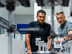 Coworkers discussing manufacturing