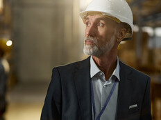 Man in hardhat looking in warehouse