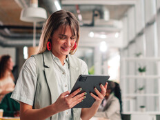 Businesswoman using tablet in modern office