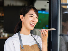 Woman uses phone voice command in cafe