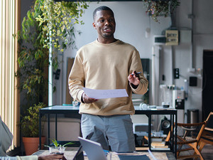 Man talking to 2 people from notes