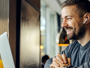 Freelancer sitting having conference call with client