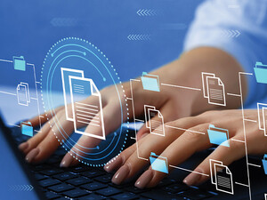 woman's hands typing on laptop