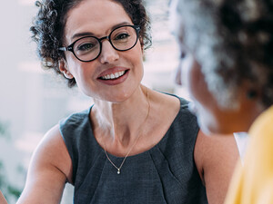 Two females talking in an office