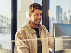 IT leader working on a large monitor display