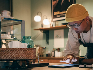 Cafe owner using technology