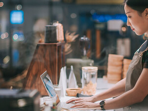 lady at counter on laptop