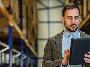 man on tablet in warehouse