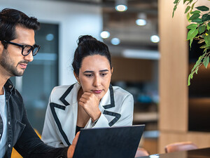 two small business owners on a laptop