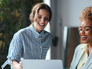 Two businesswomen viewing a laptop 