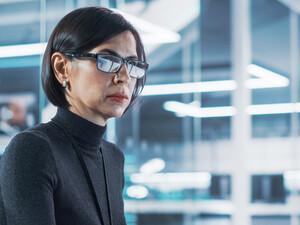 woman looks at computer monitor in office