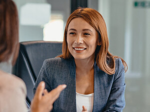 Three professionals in a discussion at an office meeting