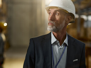 Man in hardhat looking in warehouse