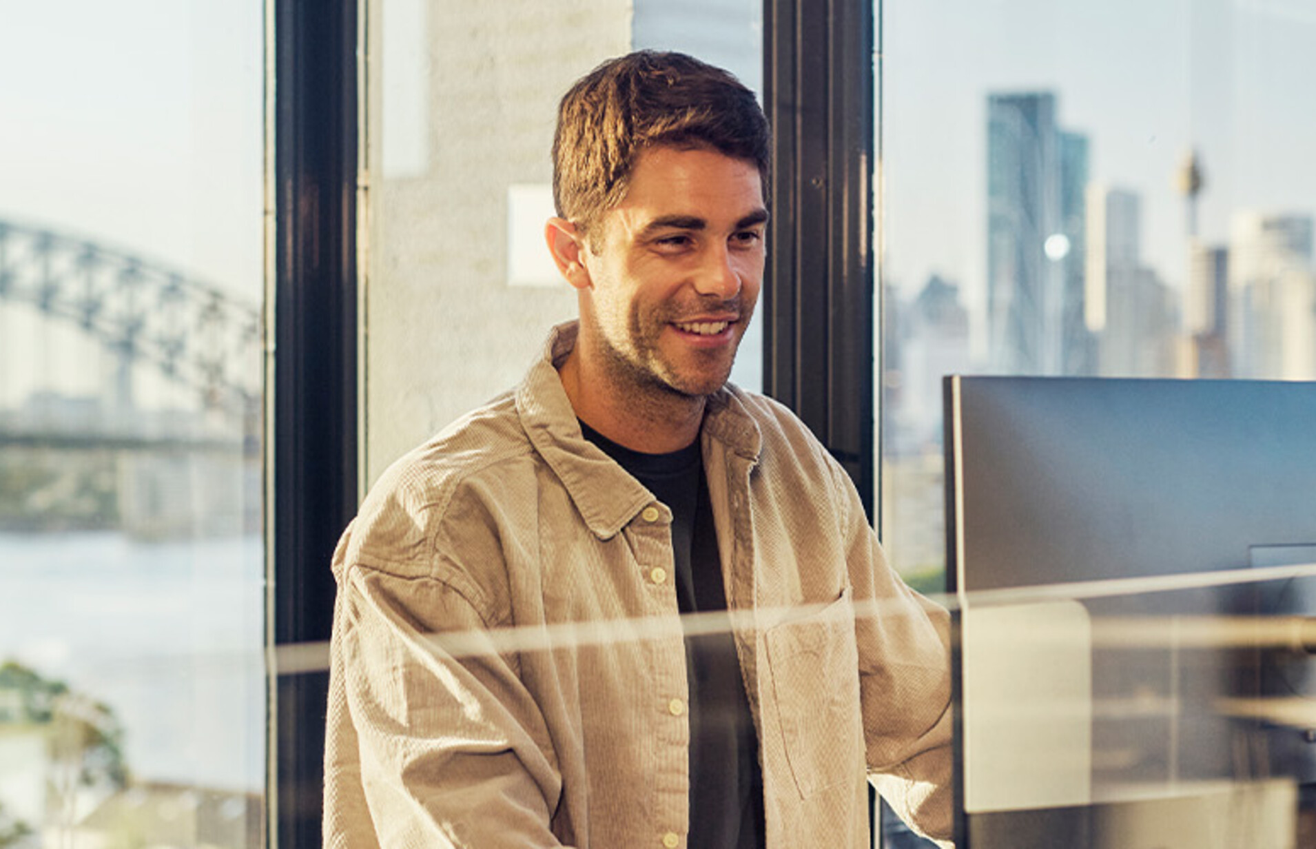 IT leader working on a large monitor display