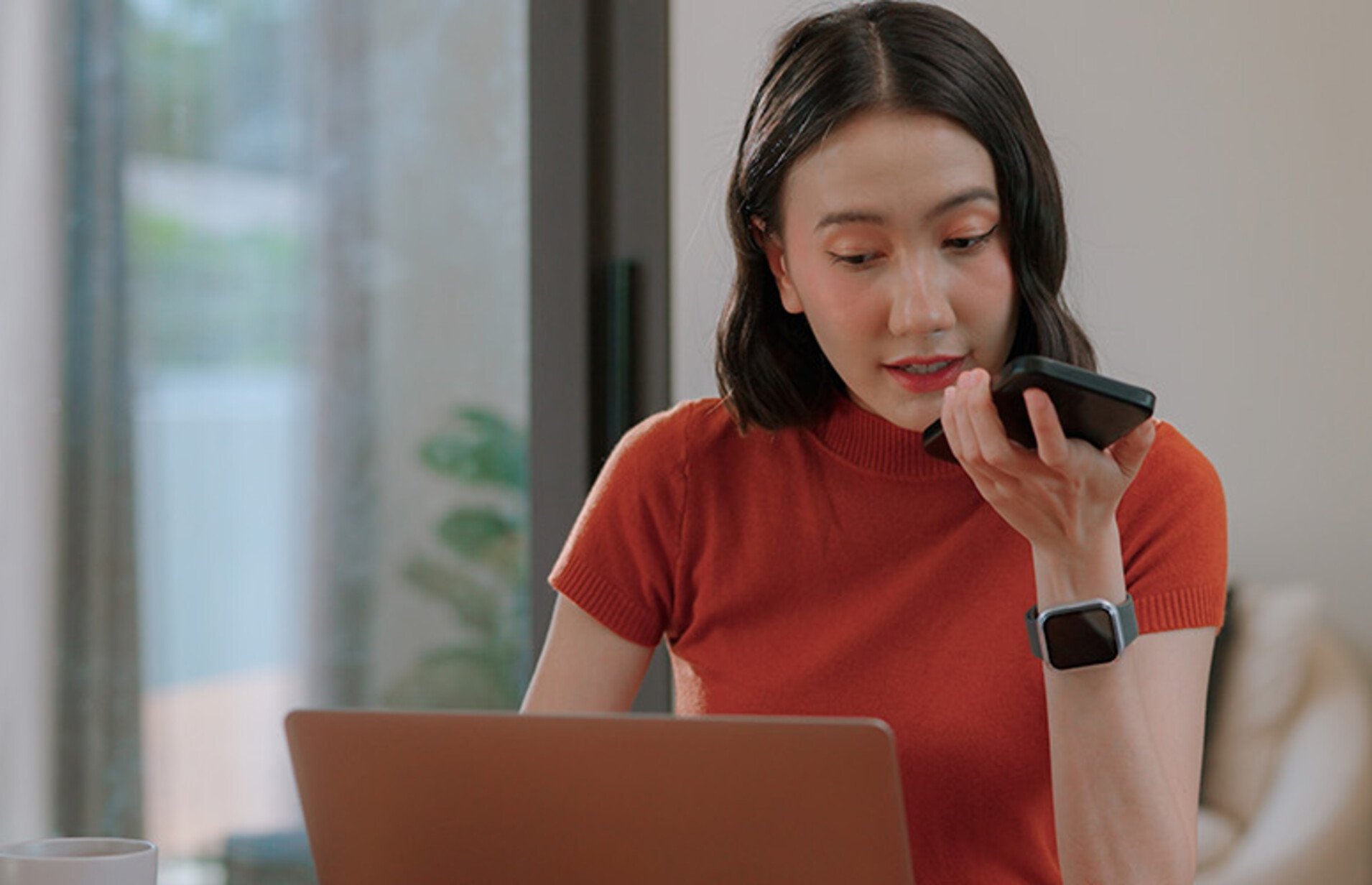 Person using phone and computer