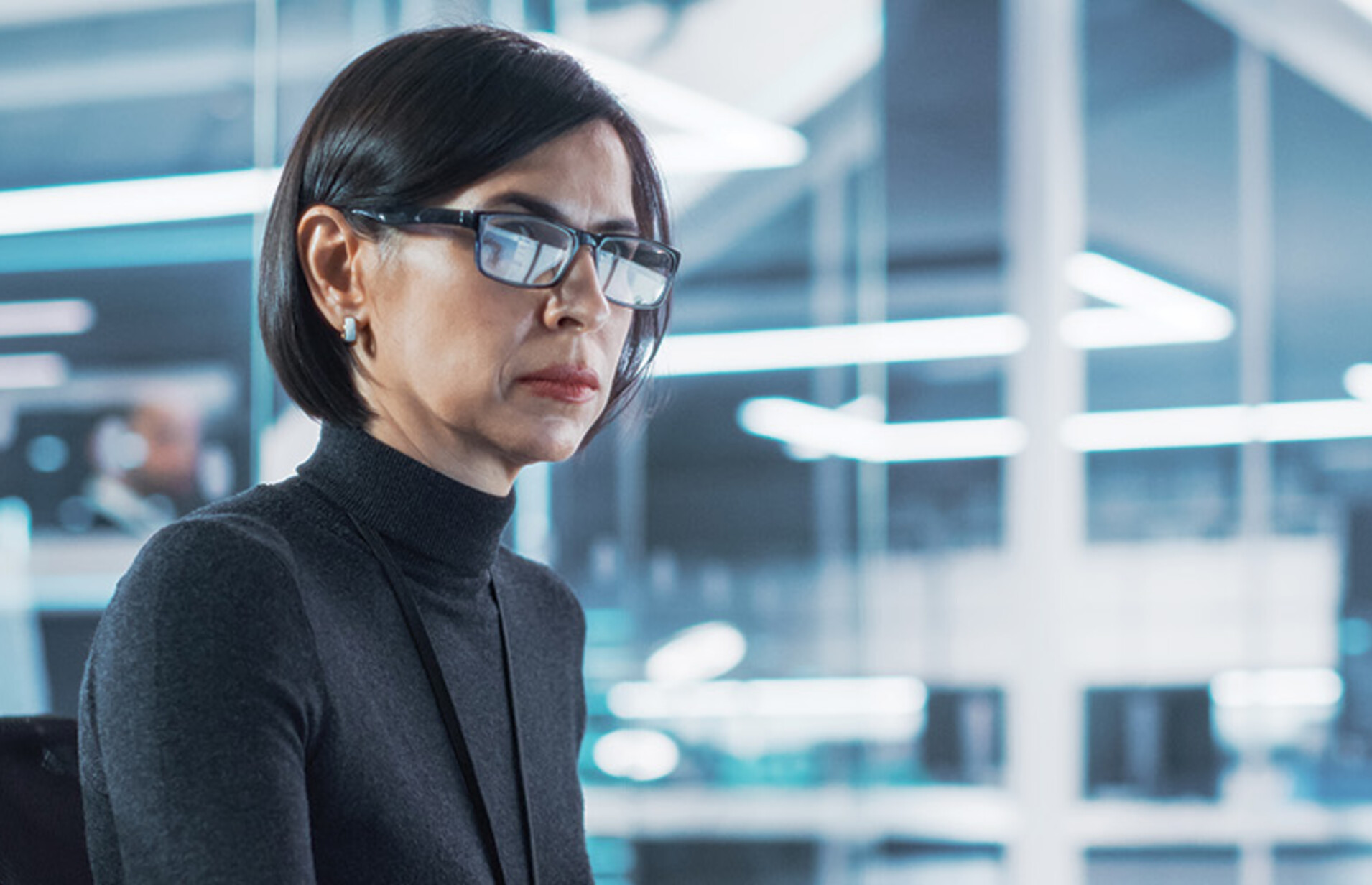 woman looks at computer monitor in office