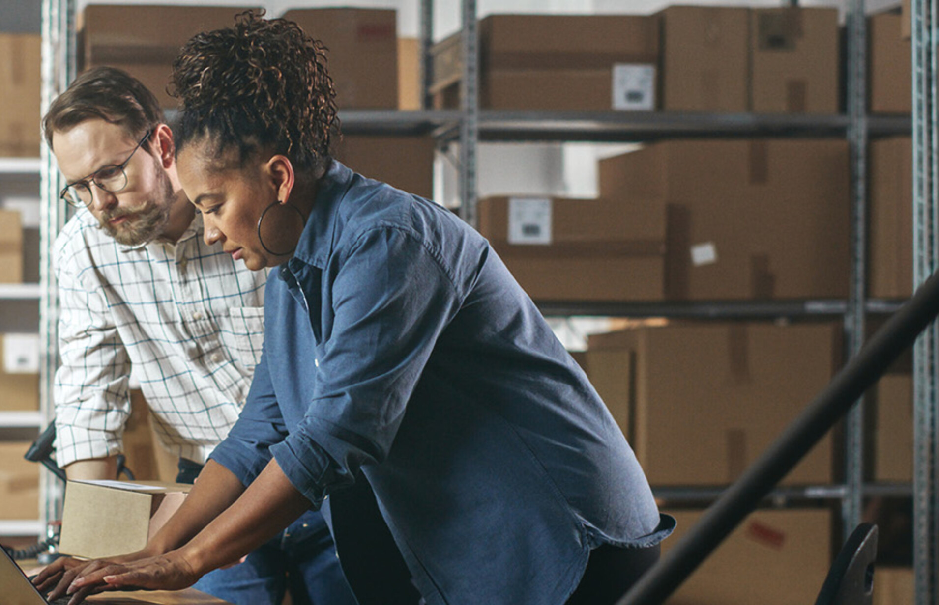 Two business owners in a warehouse