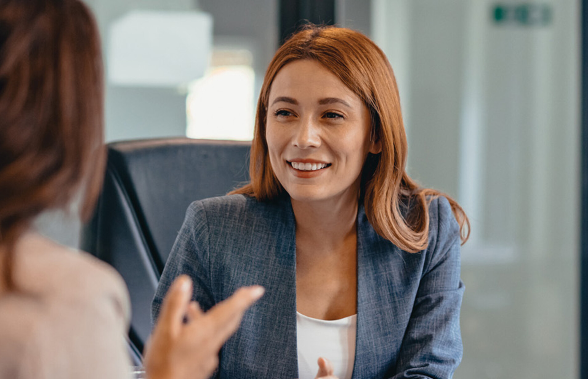 Three professionals in a discussion at an office meeting