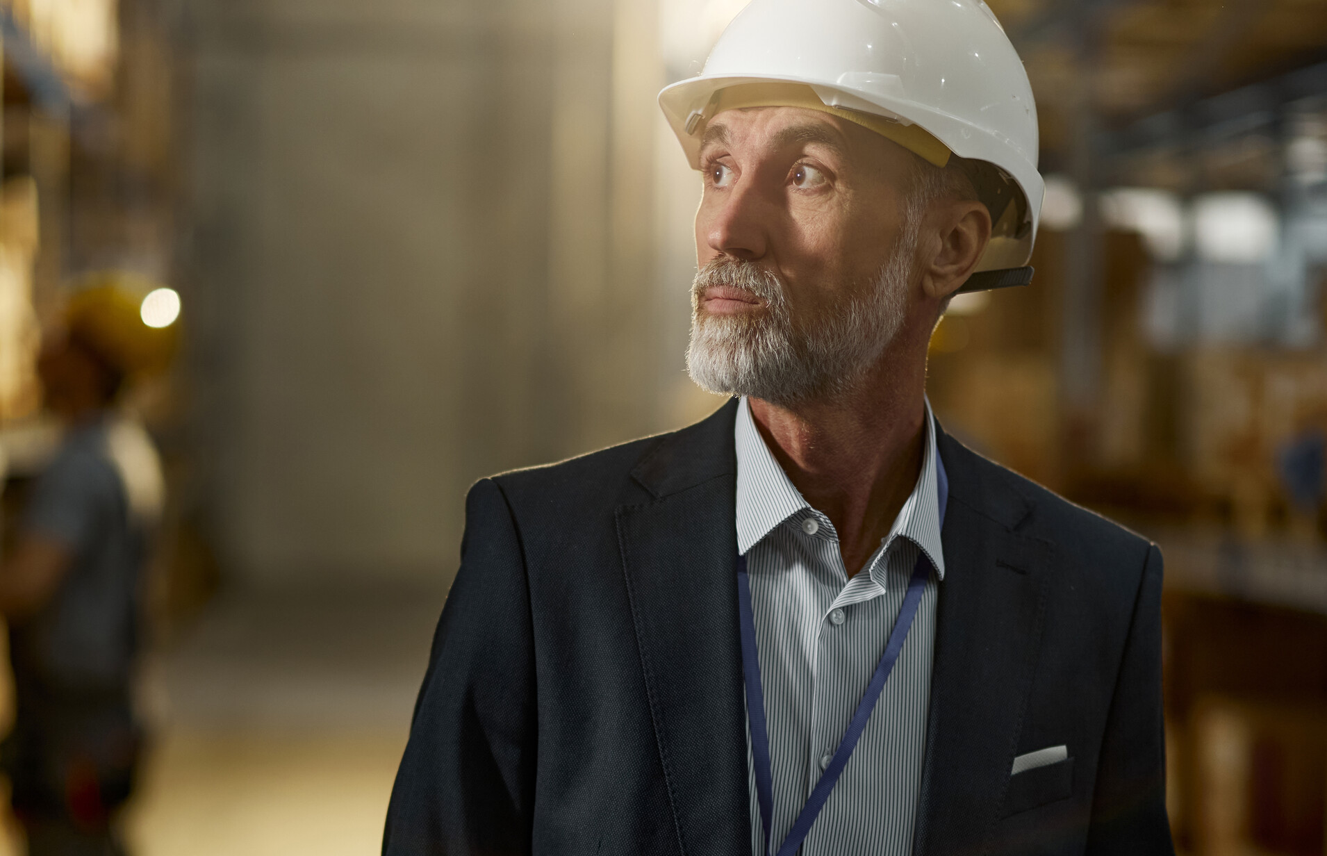 Man in hardhat looking in warehouse
