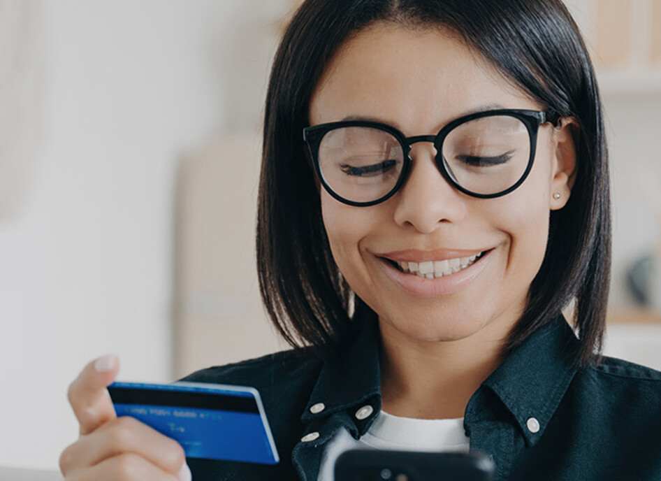 Person paying with card and a phone