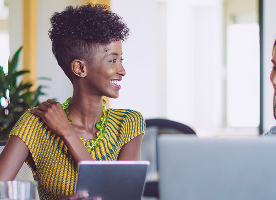 small business owners smile around computer