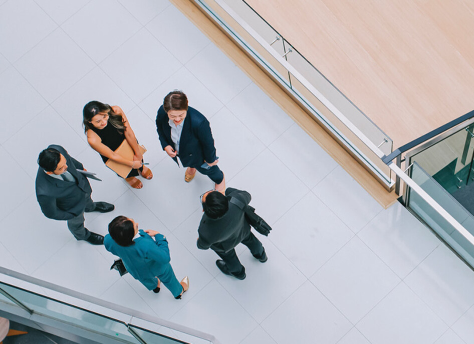 Business leaders gathered in a hallway