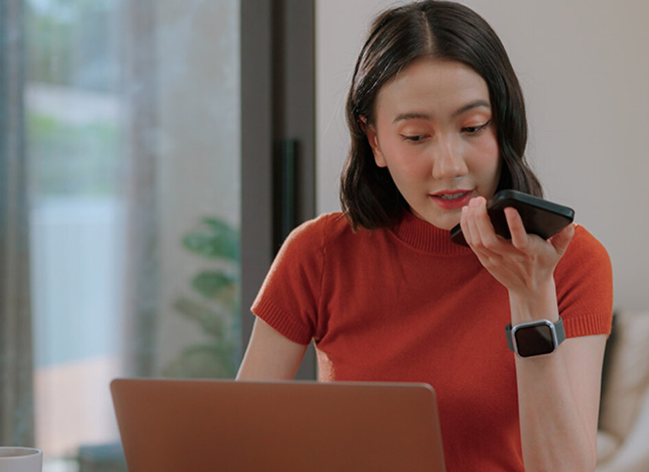 Person using phone and computer