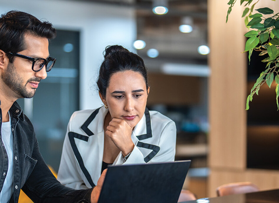 two small business owners on a laptop
