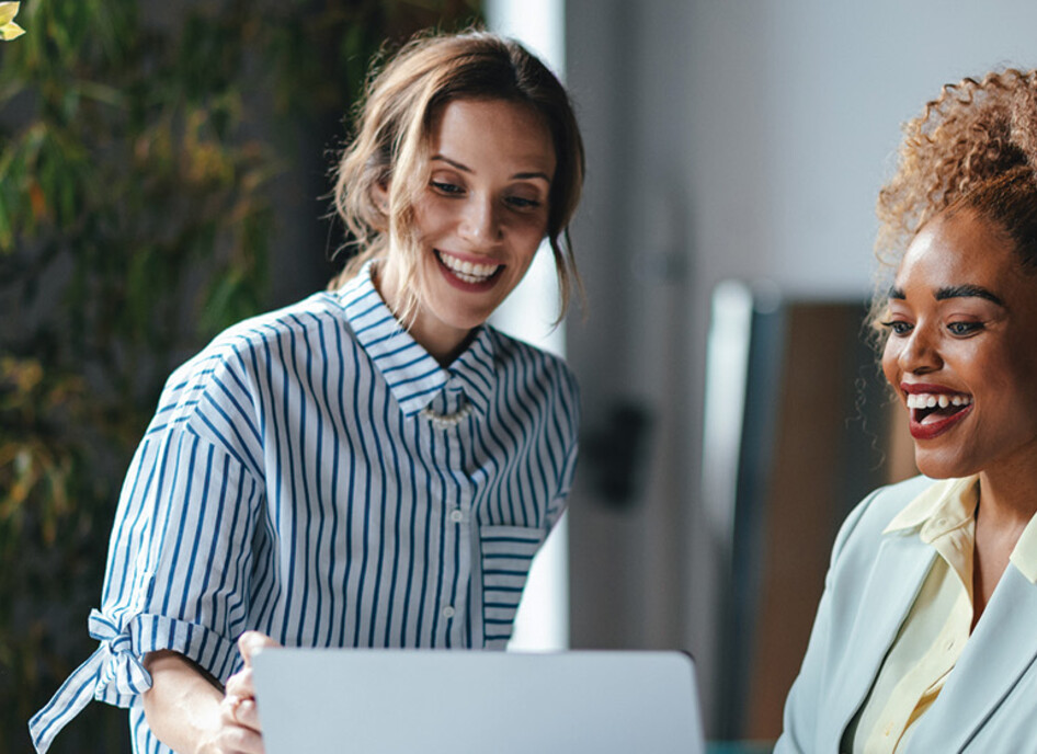 Two businesswomen viewing a laptop 
