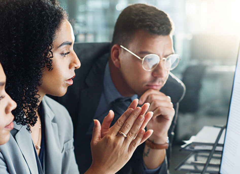 IT team looks at charts on monitor