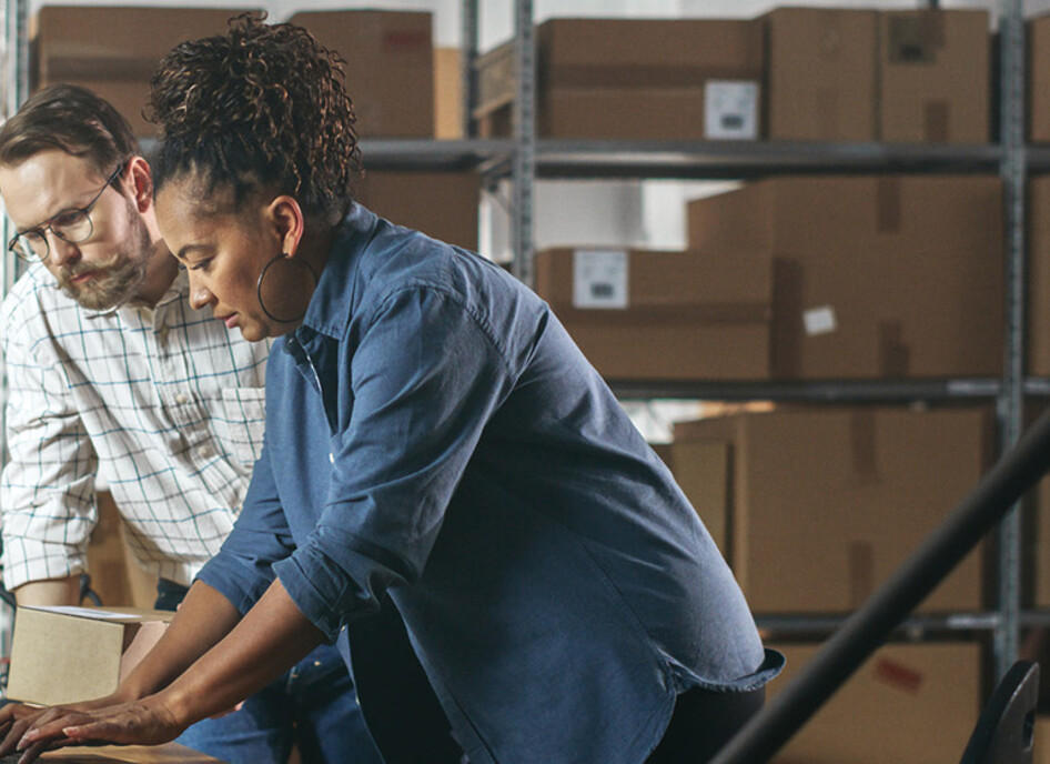 Two business owners in a warehouse