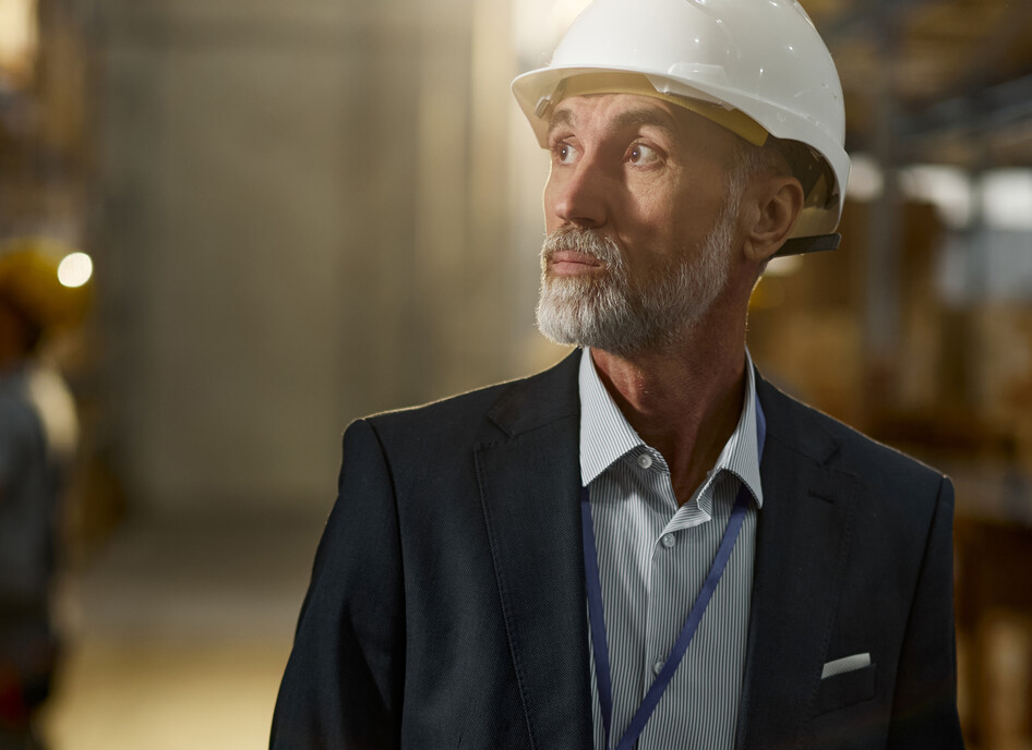 Man in hardhat looking in warehouse