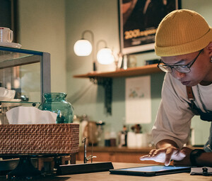 Cafe owner using technology